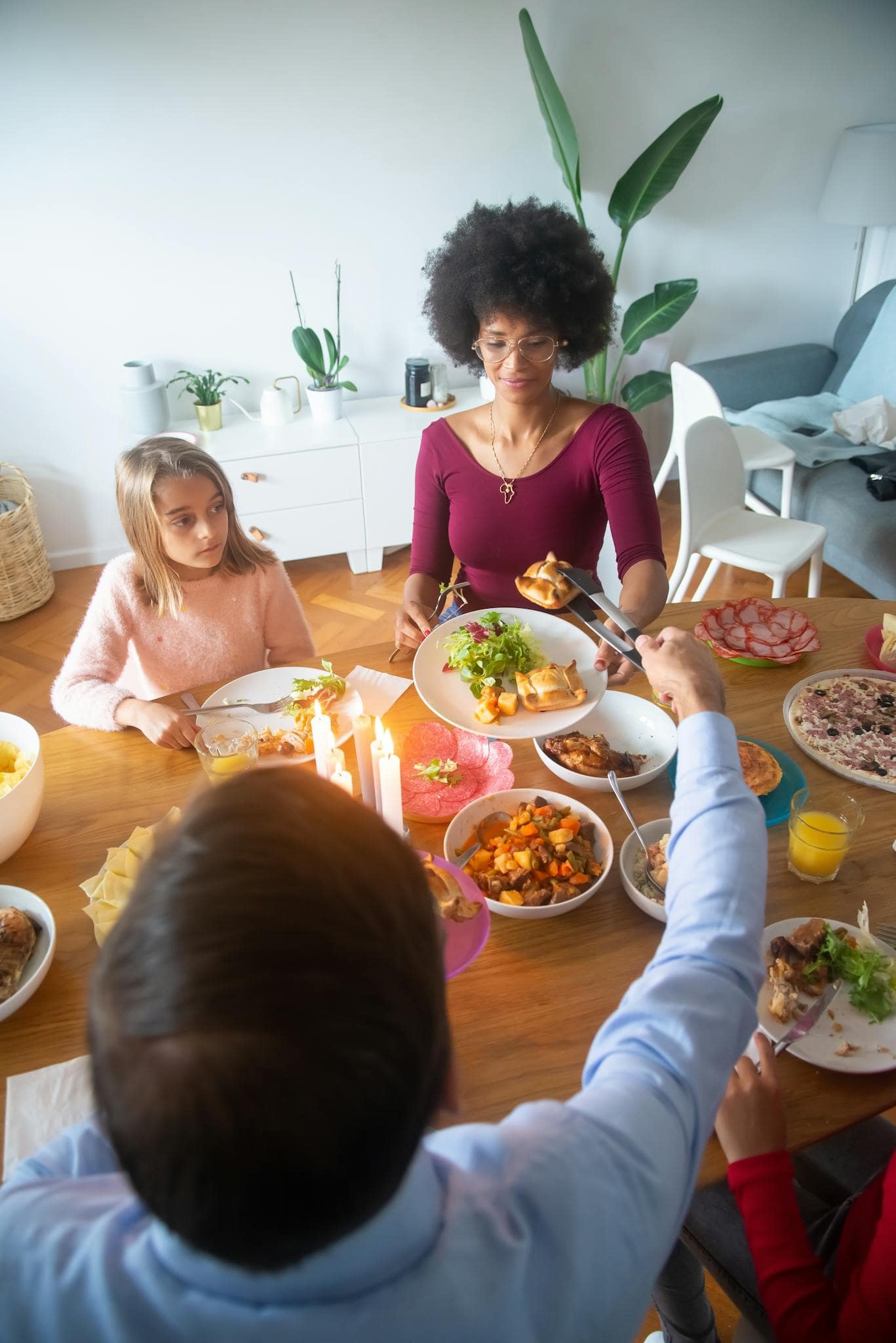 Home A Warm Family Dinner Scene With Candles And Diverse Members Sharing A Meal Indoors. 6305736 1367x2048